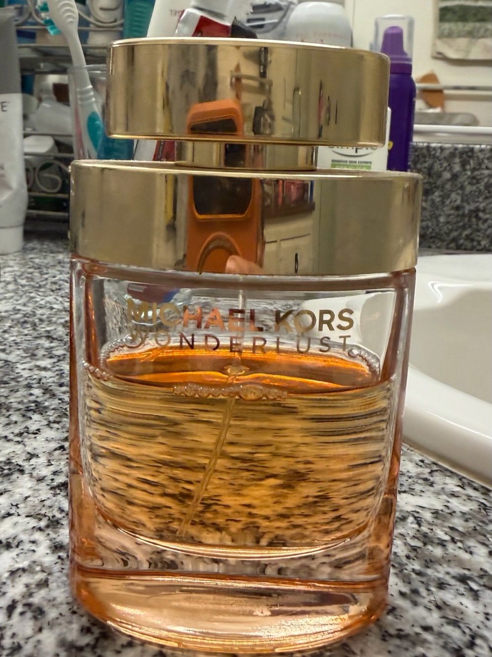 Michael Kors Wonderlust Women's Skincare Bottle - Gold and Amber 75% full